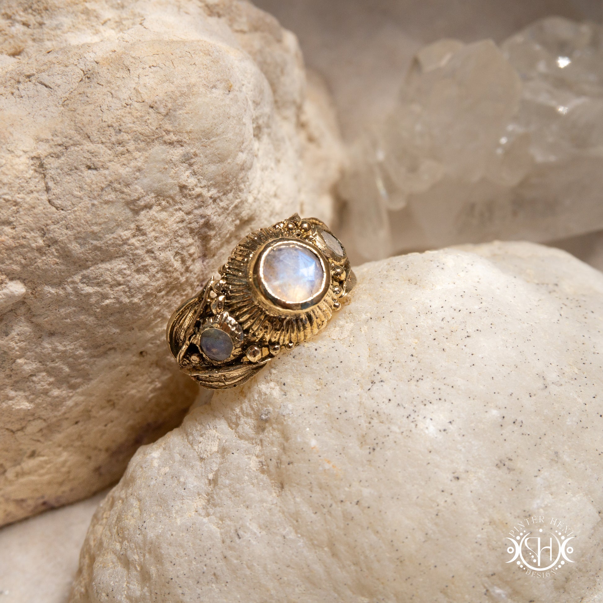 One-of-a-kind brass ring with three rainbow moonstones and sculptural carved band.