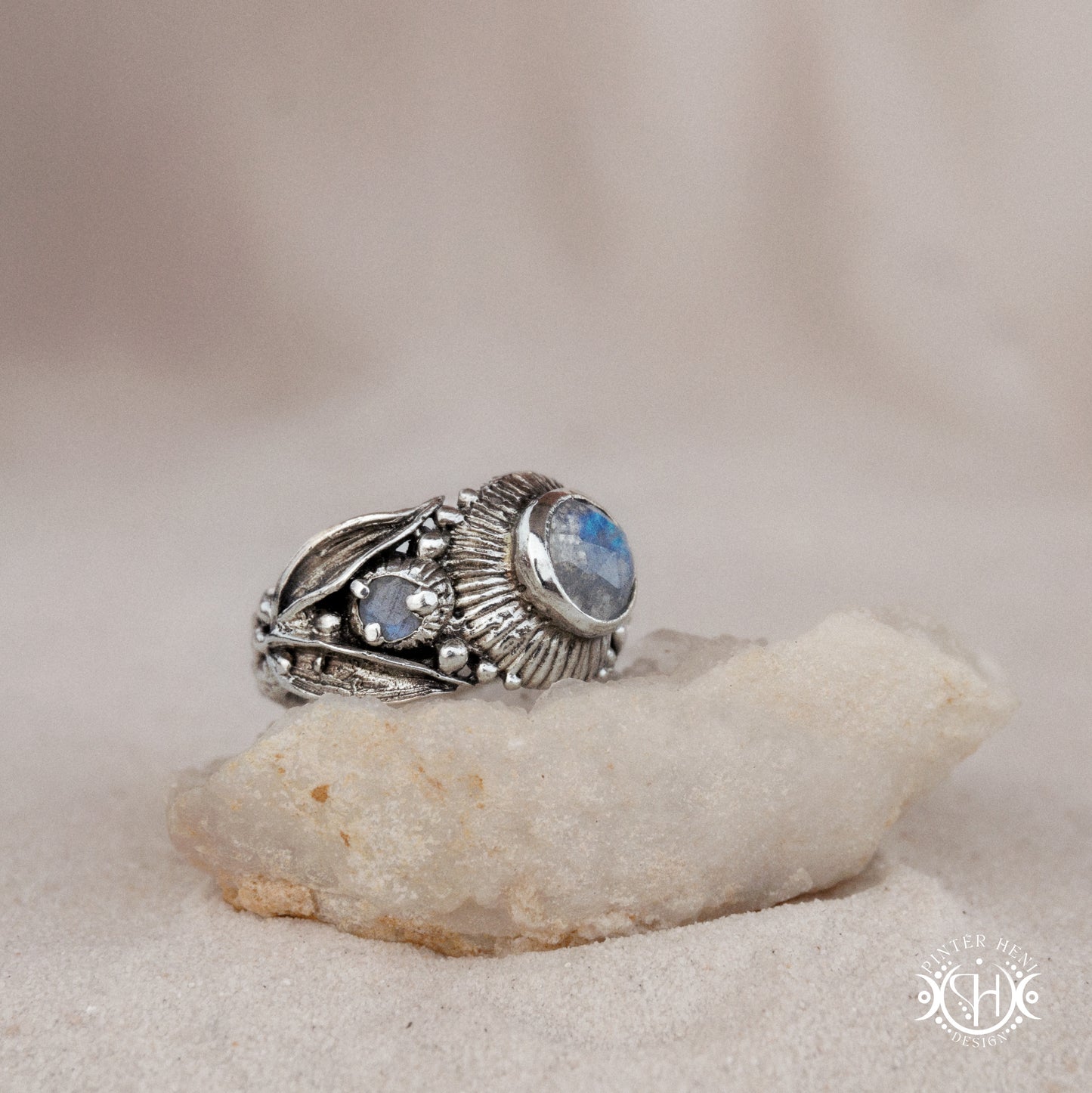 One-of-a-kind sterling silver ring with three rainbow moonstones and sculptural carved band.
