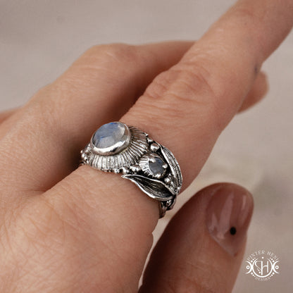 One-of-a-kind sterling silver ring with three rainbow moonstones and sculptural carved band.