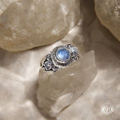 One-of-a-kind sterling silver ring with three rainbow moonstones and sculptural carved band.