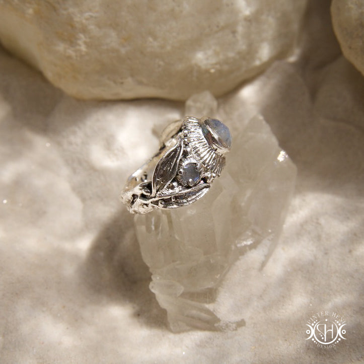 One-of-a-kind sterling silver ring with three rainbow moonstones and sculptural carved band.