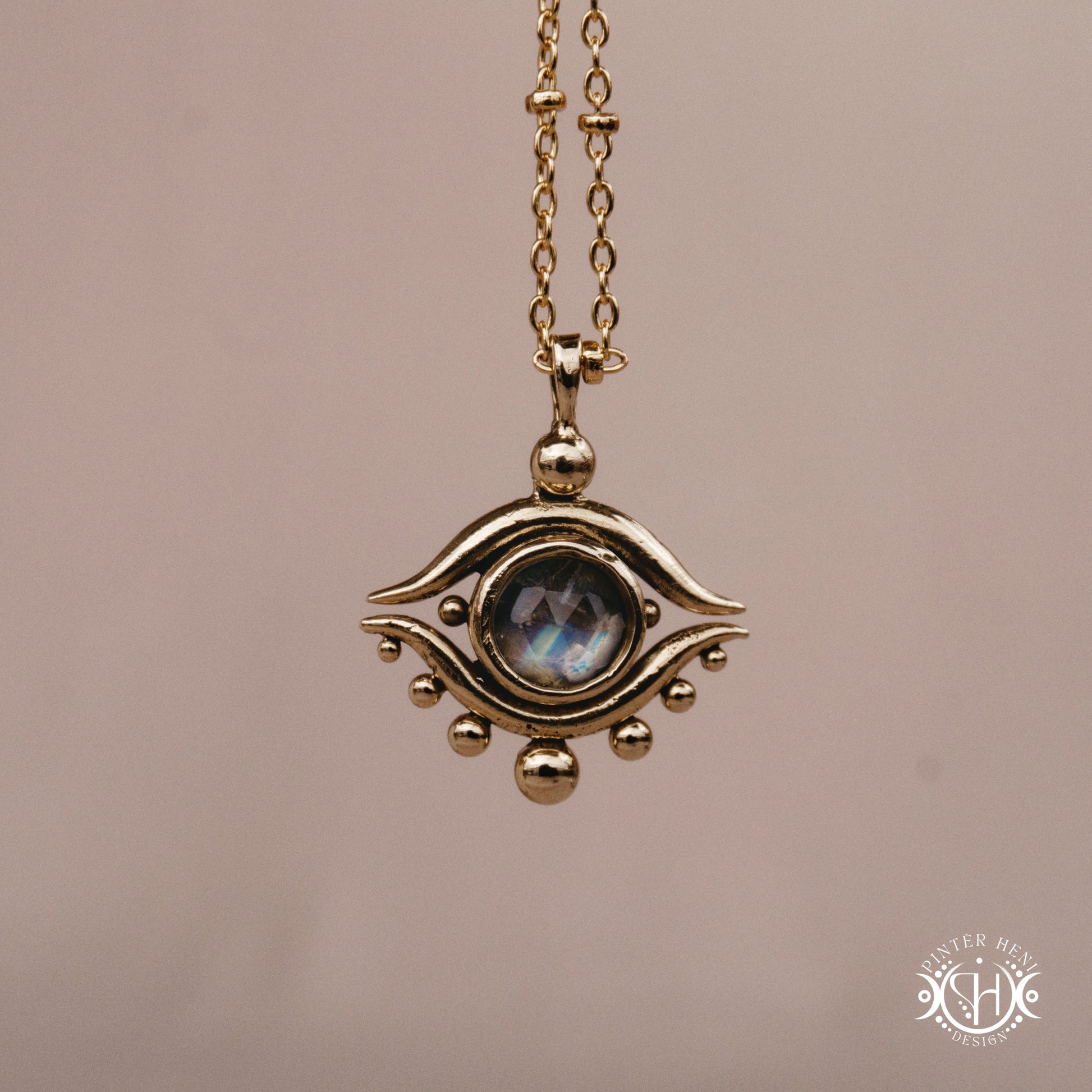 Hand-carved eye pendant in brass from the Primal Symbols collection by Pintér Heni Design, front view