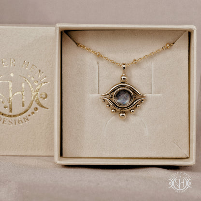 Hand-carved eye pendant in brass from the Primal Symbols collection by Pintér Heni Design, in jewelry box