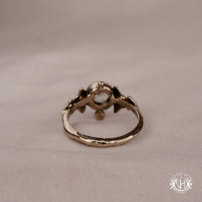 Ginkgo Ring with green presiolite stone framed by textured botanical metal forms