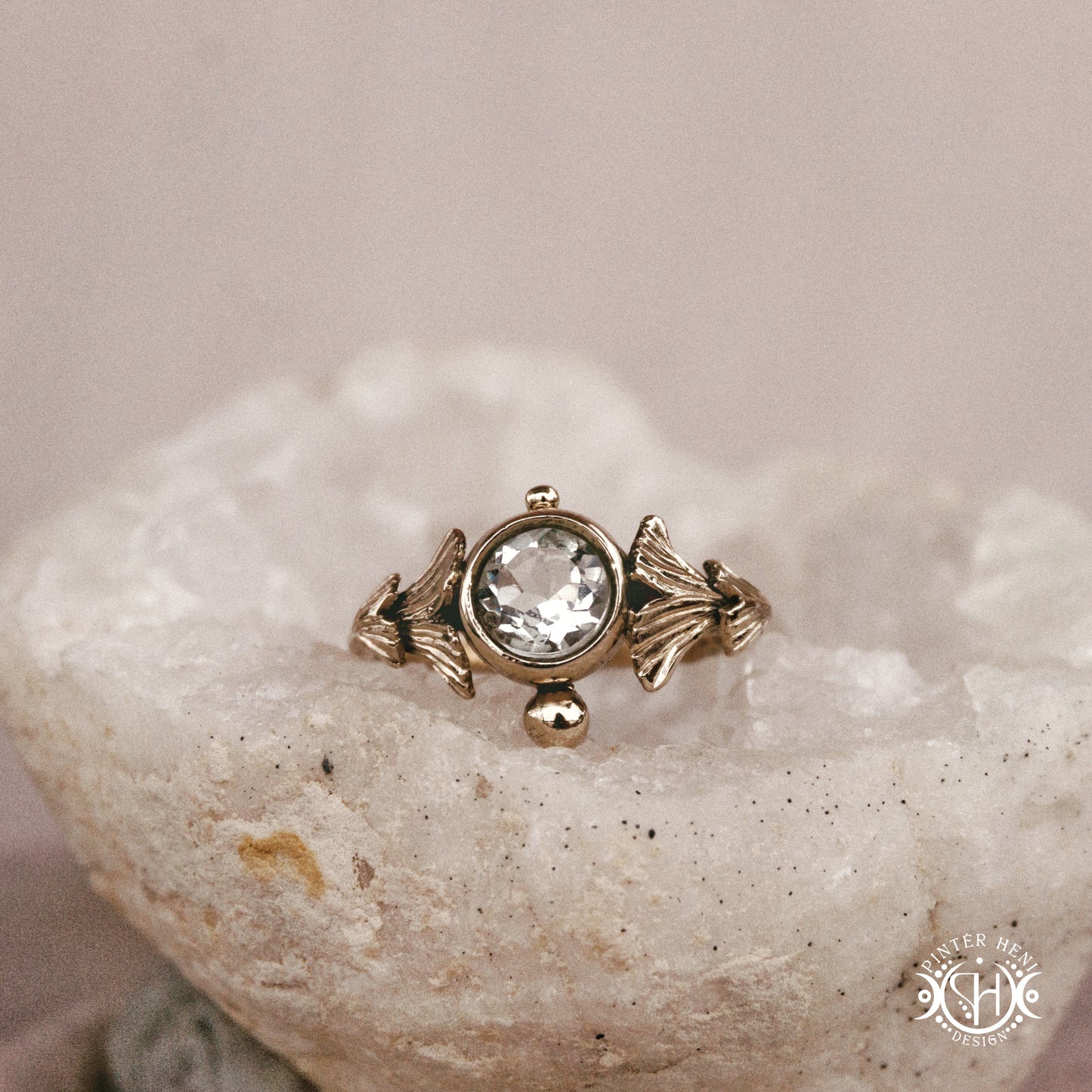Ginkgo Ring with green presiolite stone framed by textured botanical metal forms