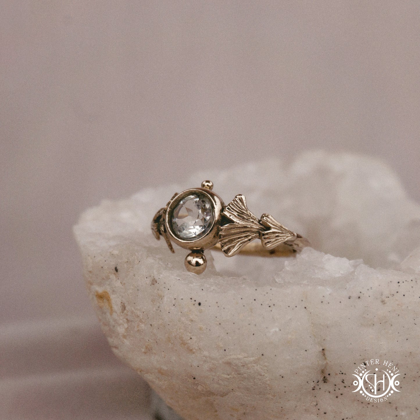Ginkgo Ring with green presiolite stone framed by textured botanical metal forms