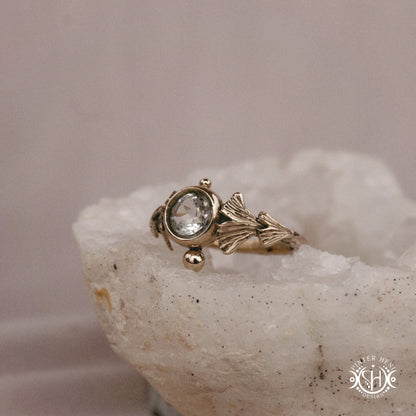 Ginkgo Ring with green presiolite stone framed by textured botanical metal forms