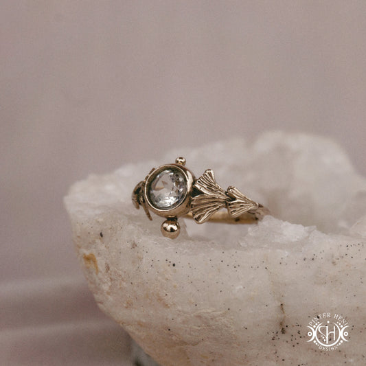 Ginkgo Ring with green presiolite stone framed by textured botanical metal forms