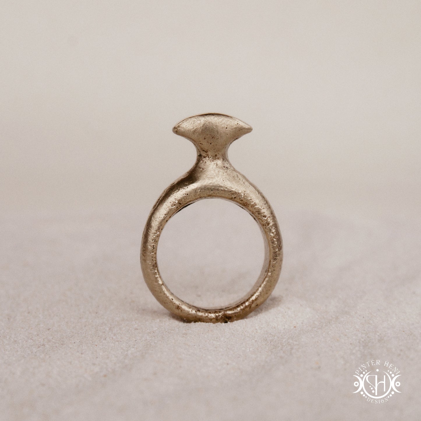 Glyph Ring handmade sandcast brass ring with curved sculptural top and ancient symbolic character