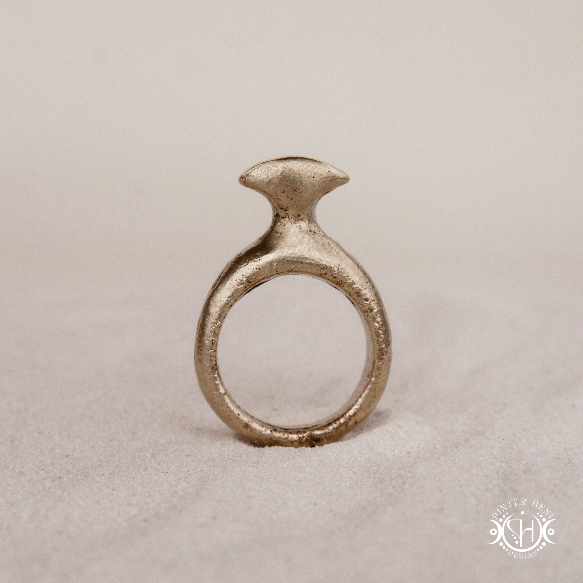 Glyph Ring handmade sandcast brass ring with curved sculptural top and ancient symbolic character