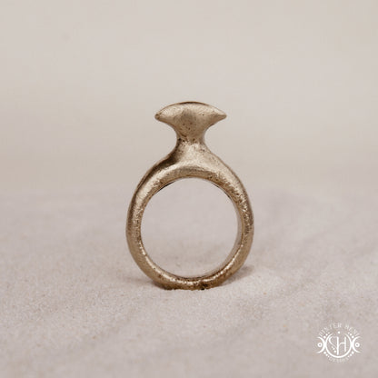 Glyph Ring handmade sandcast brass ring with curved sculptural top and ancient symbolic character