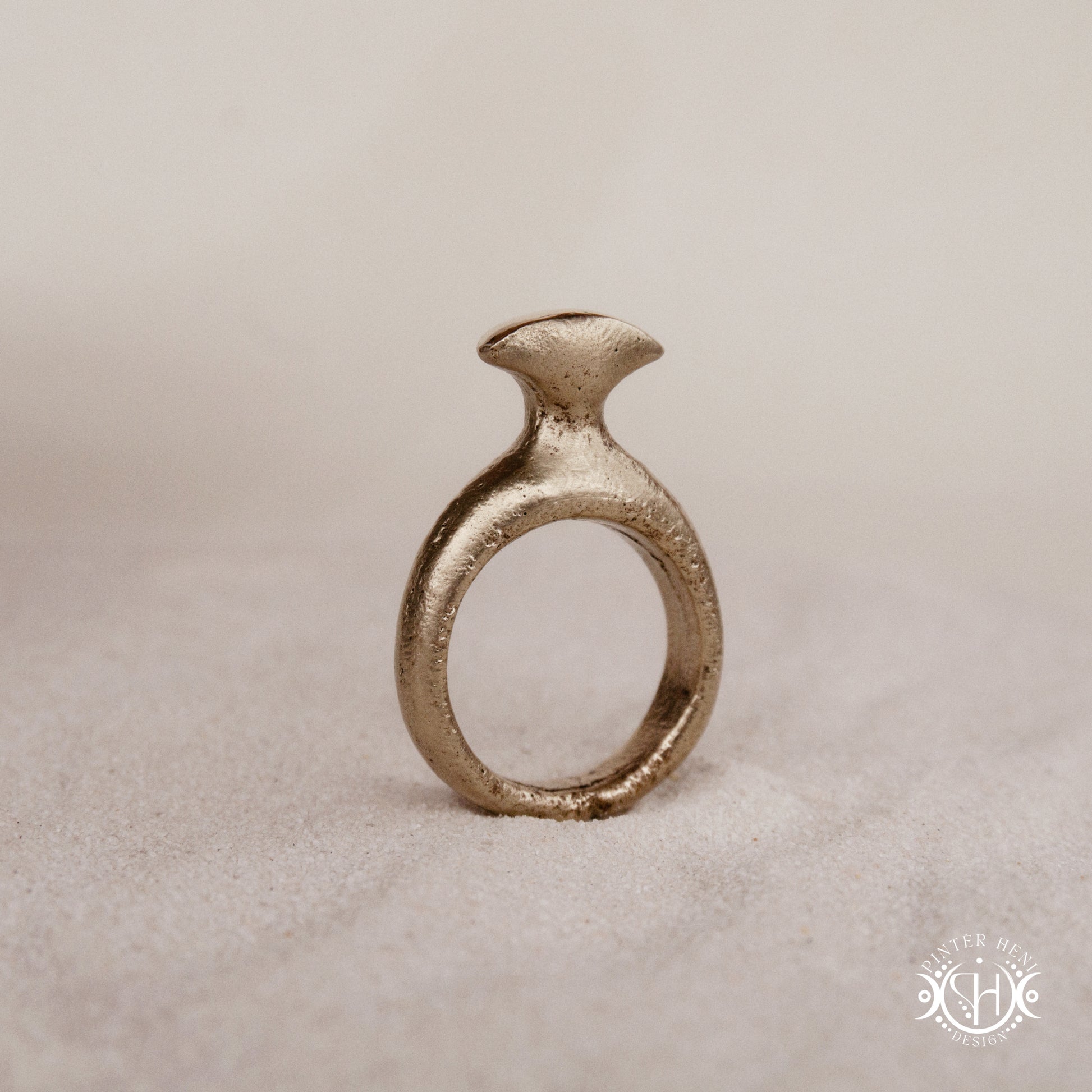 Glyph Ring handmade sandcast brass ring with curved sculptural top and ancient symbolic character