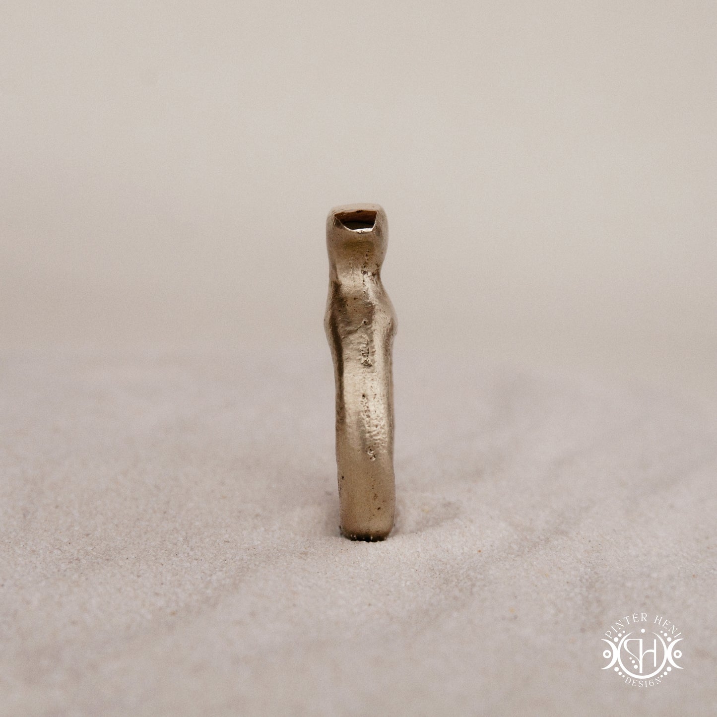 Glyph Ring handmade sandcast brass ring with curved sculptural top and ancient symbolic character