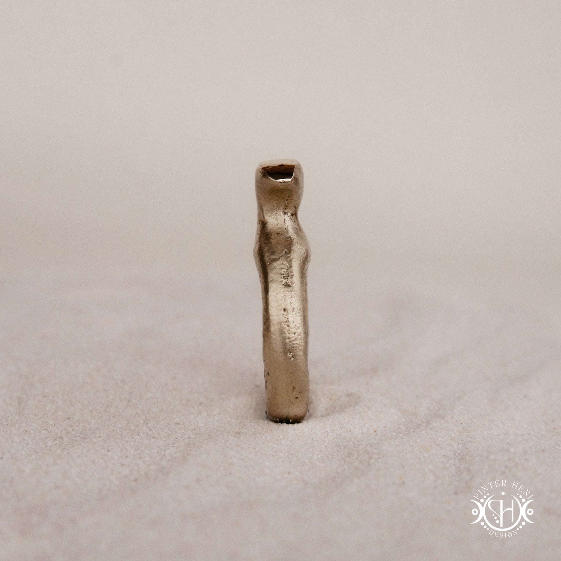 Glyph Ring handmade sandcast brass ring with curved sculptural top and ancient symbolic character