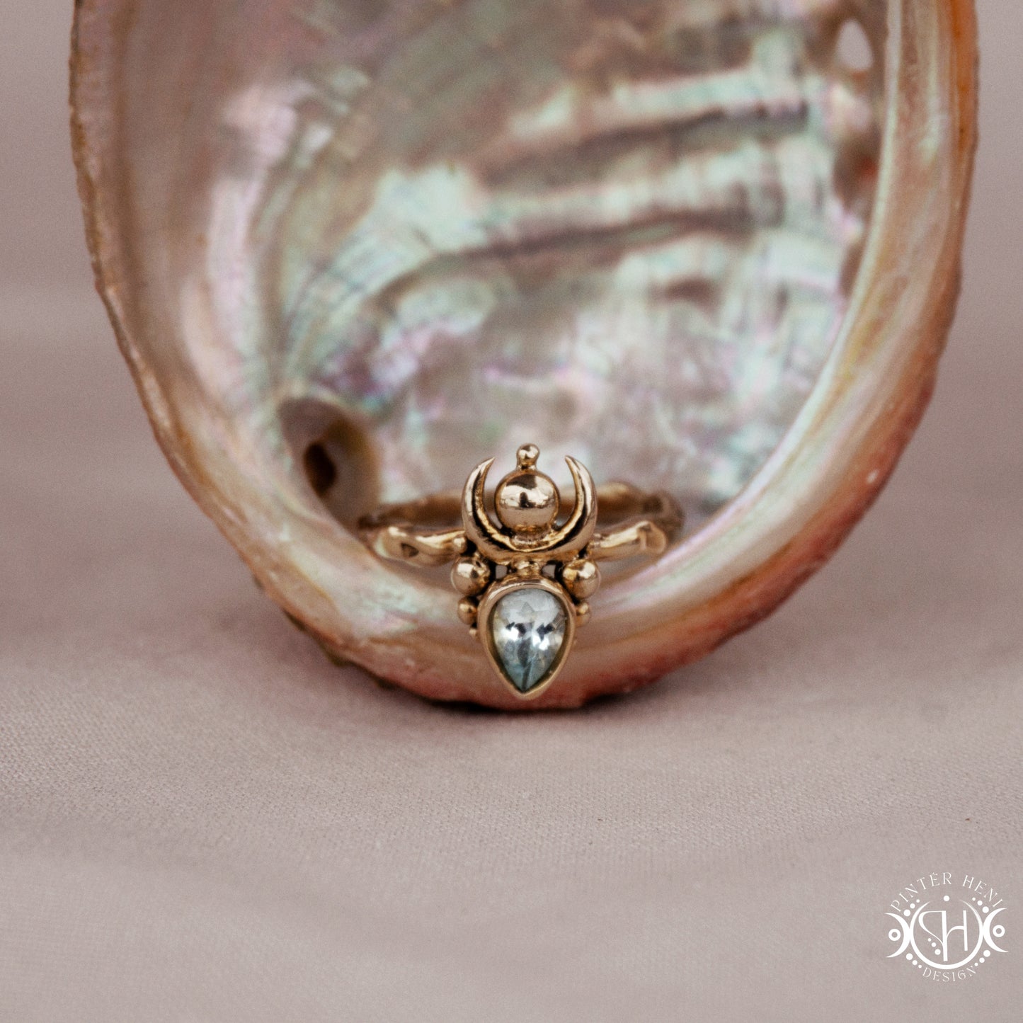 Handmade small scale Hecate ring with aquamarine in sculptural feminine design, in a shell