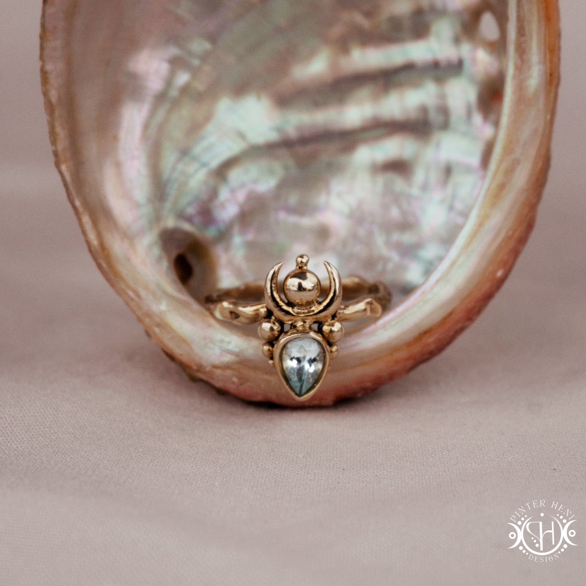 Handmade small scale Hecate ring with aquamarine in sculptural feminine design, in a shell