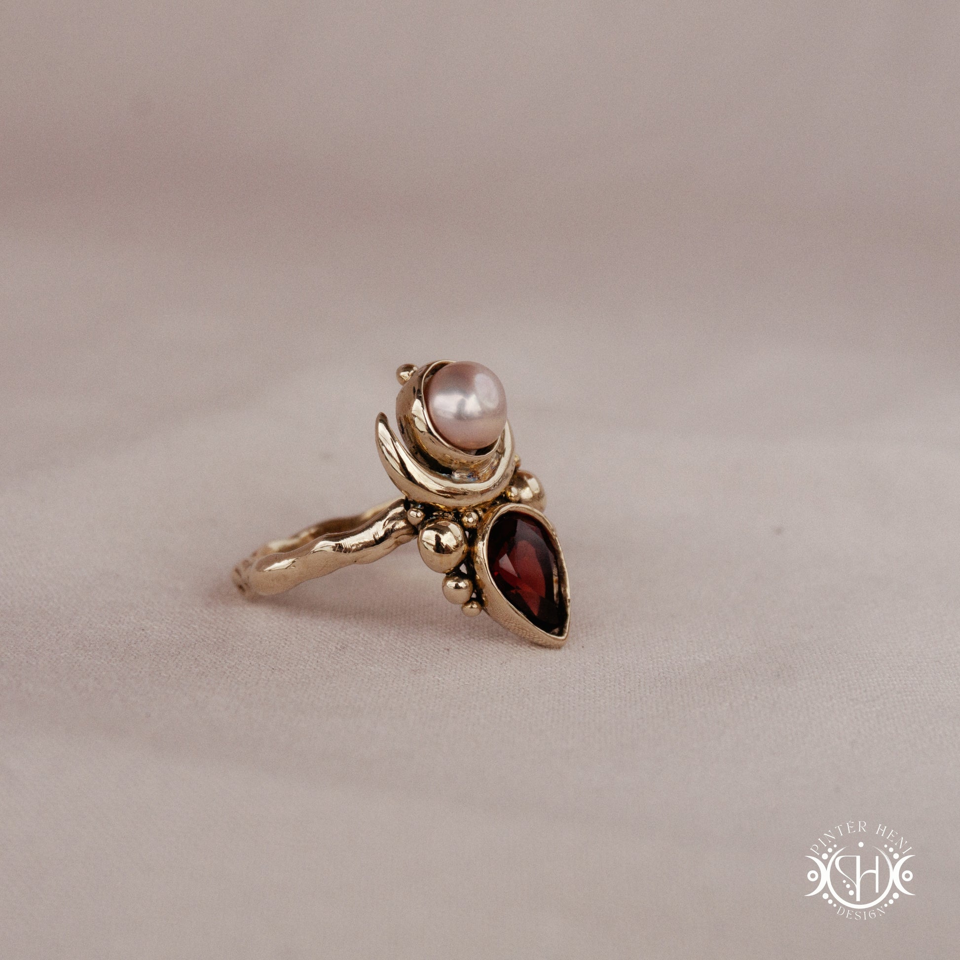 Handmade Hecate ring with garnet and pearl in sculptural feminine design