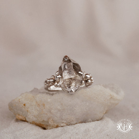 One-of-a-kind sterling silver ring featuring a raw Herkimer diamond. Organic sculptural design with natural crystal texture.