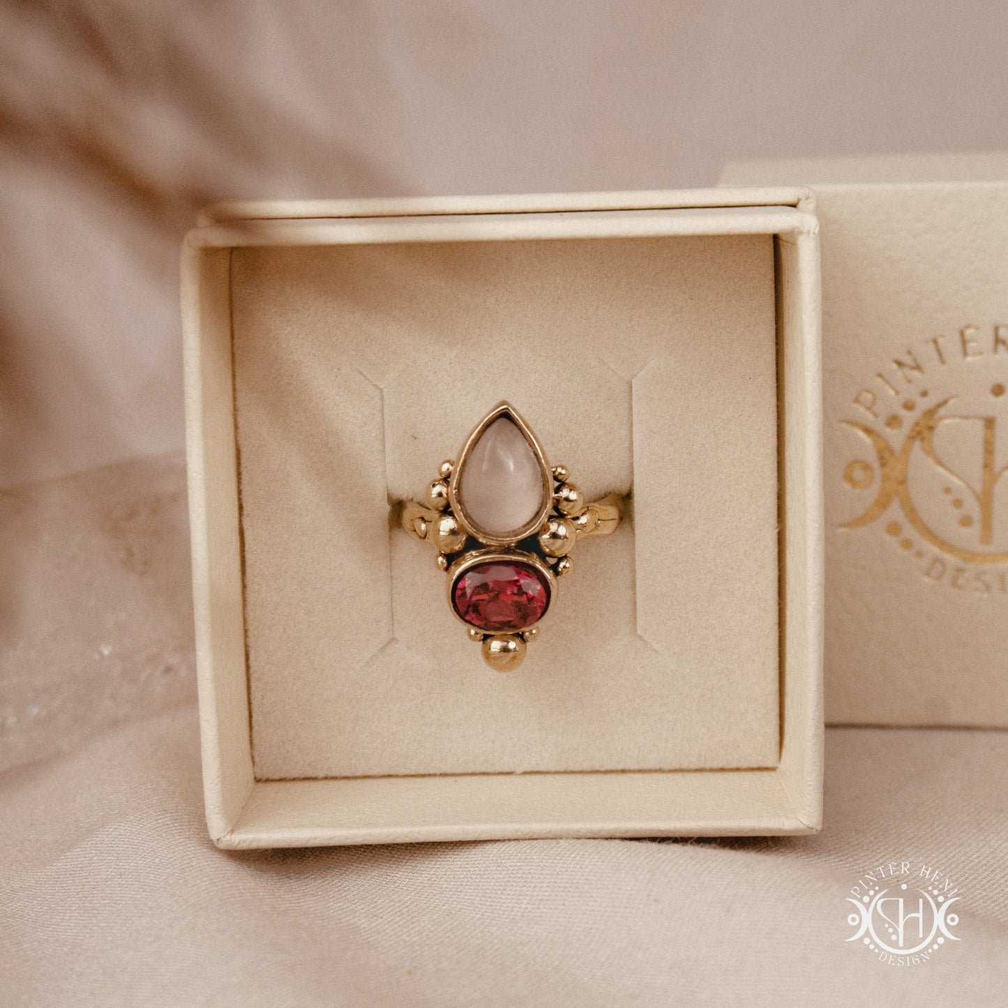 Handmade Hestia ring with rose quartz and garnet in balanced sculptural setting, in branded jewerlry box