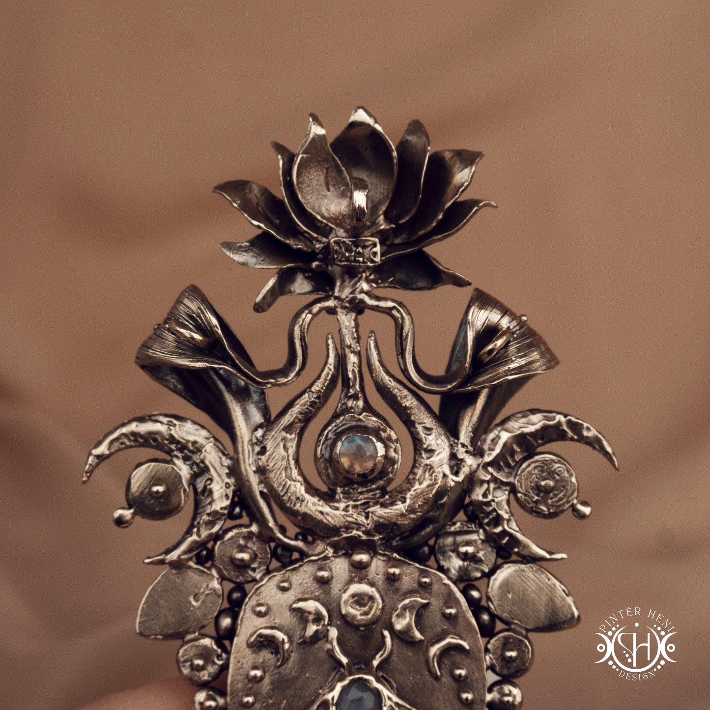 Large brass statement pendant with crystals and gemstones arranged in a crown-like sculptural form, Ishtar’s Oasis necklace.