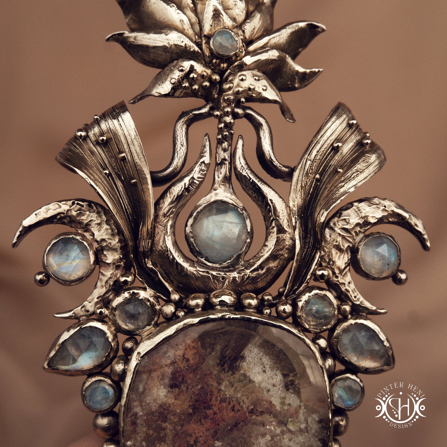 Large brass statement pendant with crystals and gemstones arranged in a crown-like sculptural form, Ishtar’s Oasis necklace.