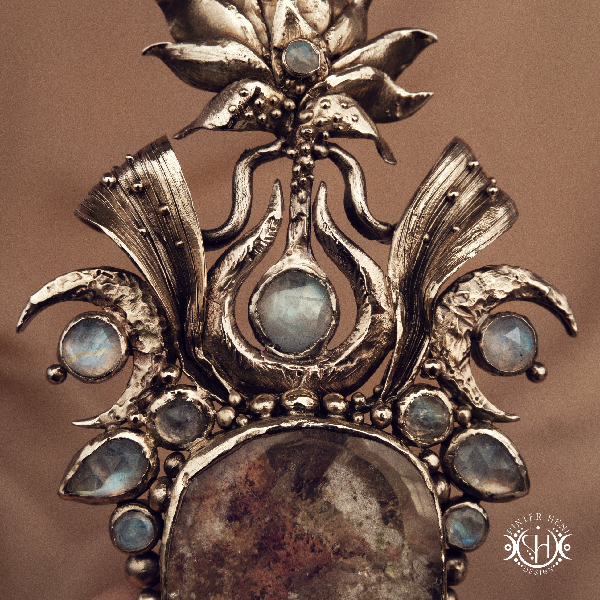 Large brass statement pendant with crystals and gemstones arranged in a crown-like sculptural form, Ishtar’s Oasis necklace.