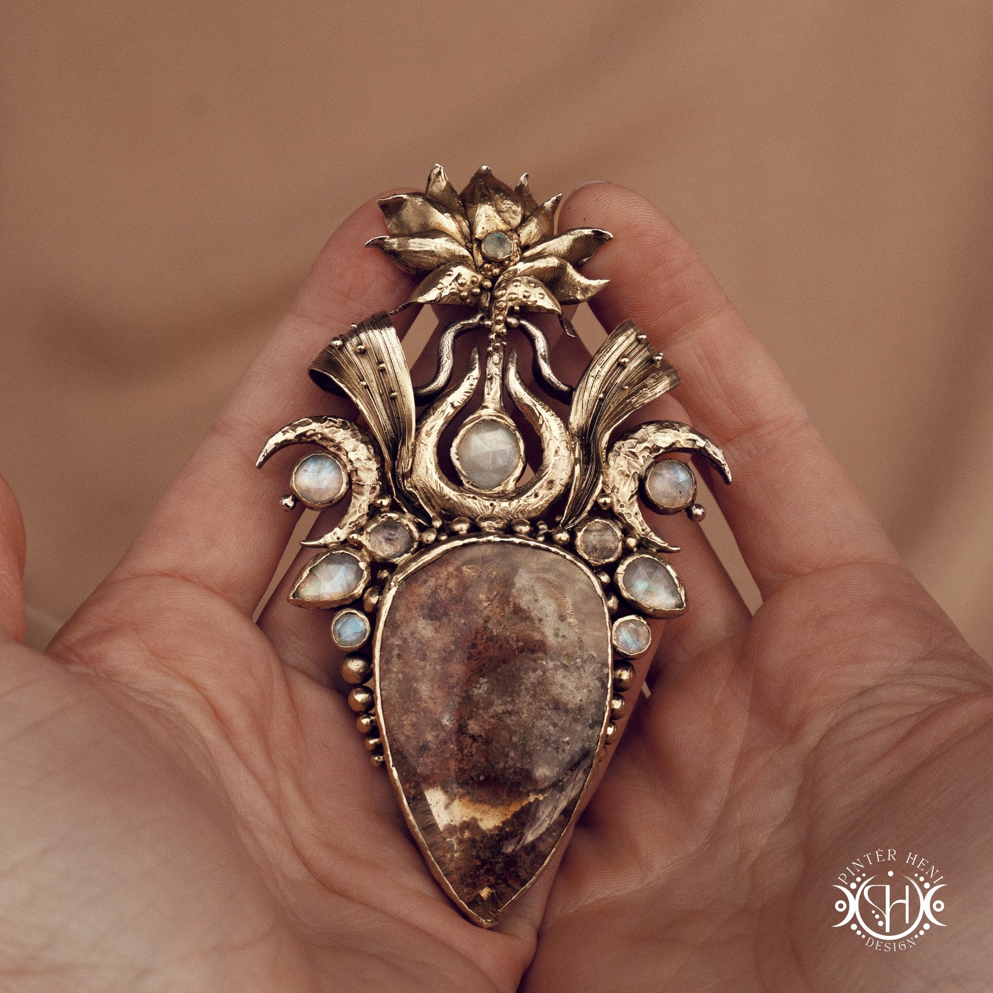Large brass statement pendant with crystals and gemstones arranged in a crown-like sculptural form, Ishtar’s Oasis necklace.