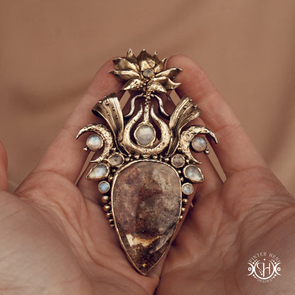Large brass statement pendant with crystals and gemstones arranged in a crown-like sculptural form, Ishtar’s Oasis necklace.