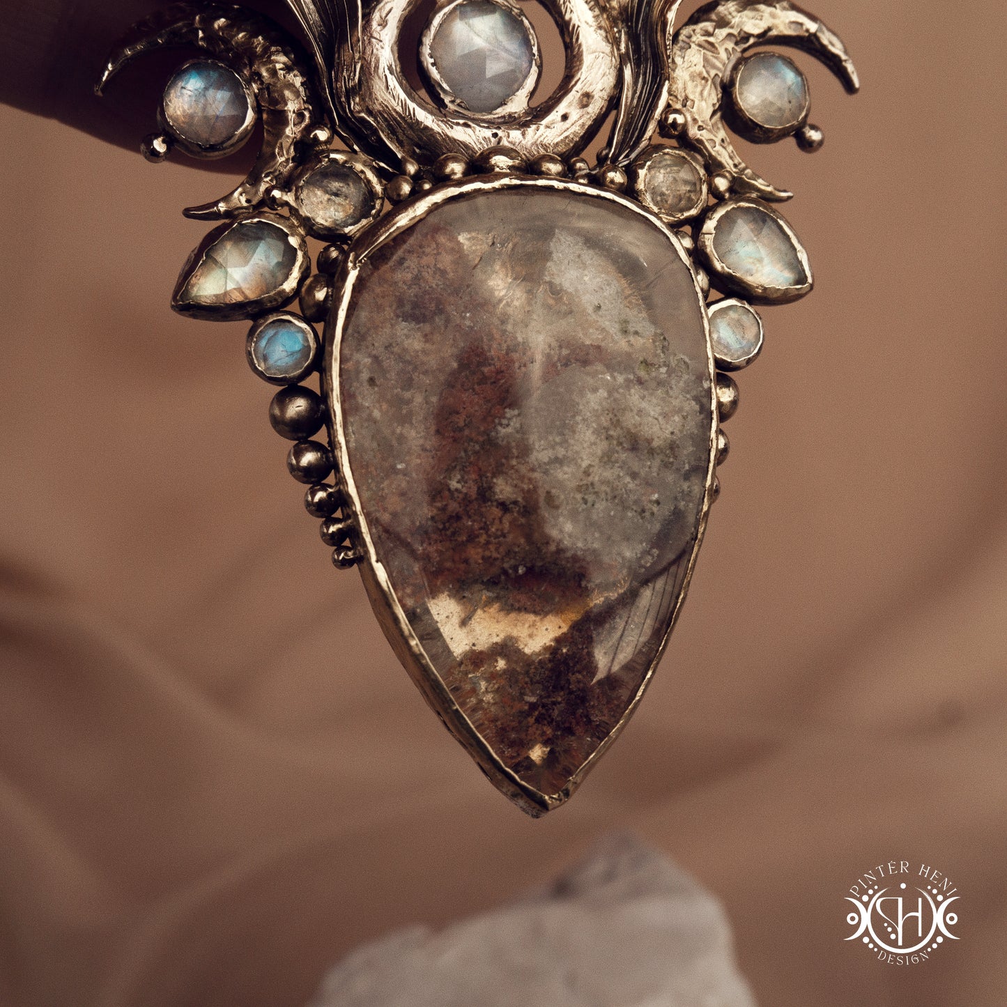Large brass statement pendant with crystals and gemstones arranged in a crown-like sculptural form, Ishtar’s Oasis necklace.