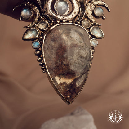 Large brass statement pendant with crystals and gemstones arranged in a crown-like sculptural form, Ishtar’s Oasis necklace.