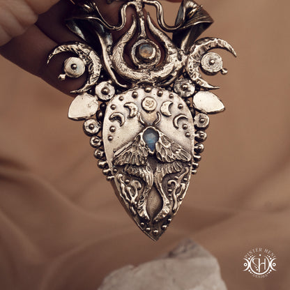 Large brass statement pendant with crystals and gemstones arranged in a crown-like sculptural form, Ishtar’s Oasis necklace.