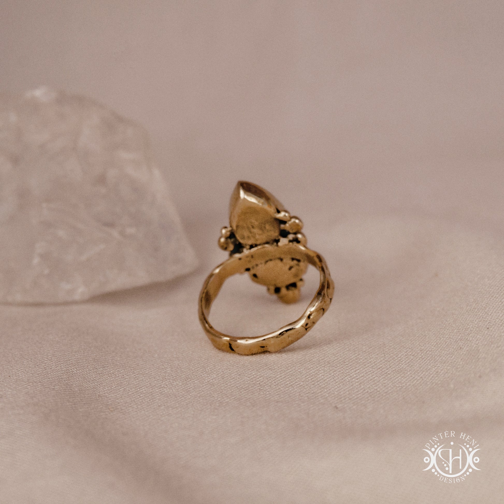 Handmade Kore ring with rose quartz and aquamarine in balanced sculptural setting