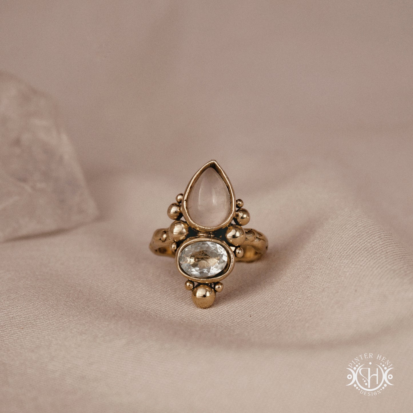 Handmade Kore ring with rose quartz and aquamarine in balanced sculptural setting