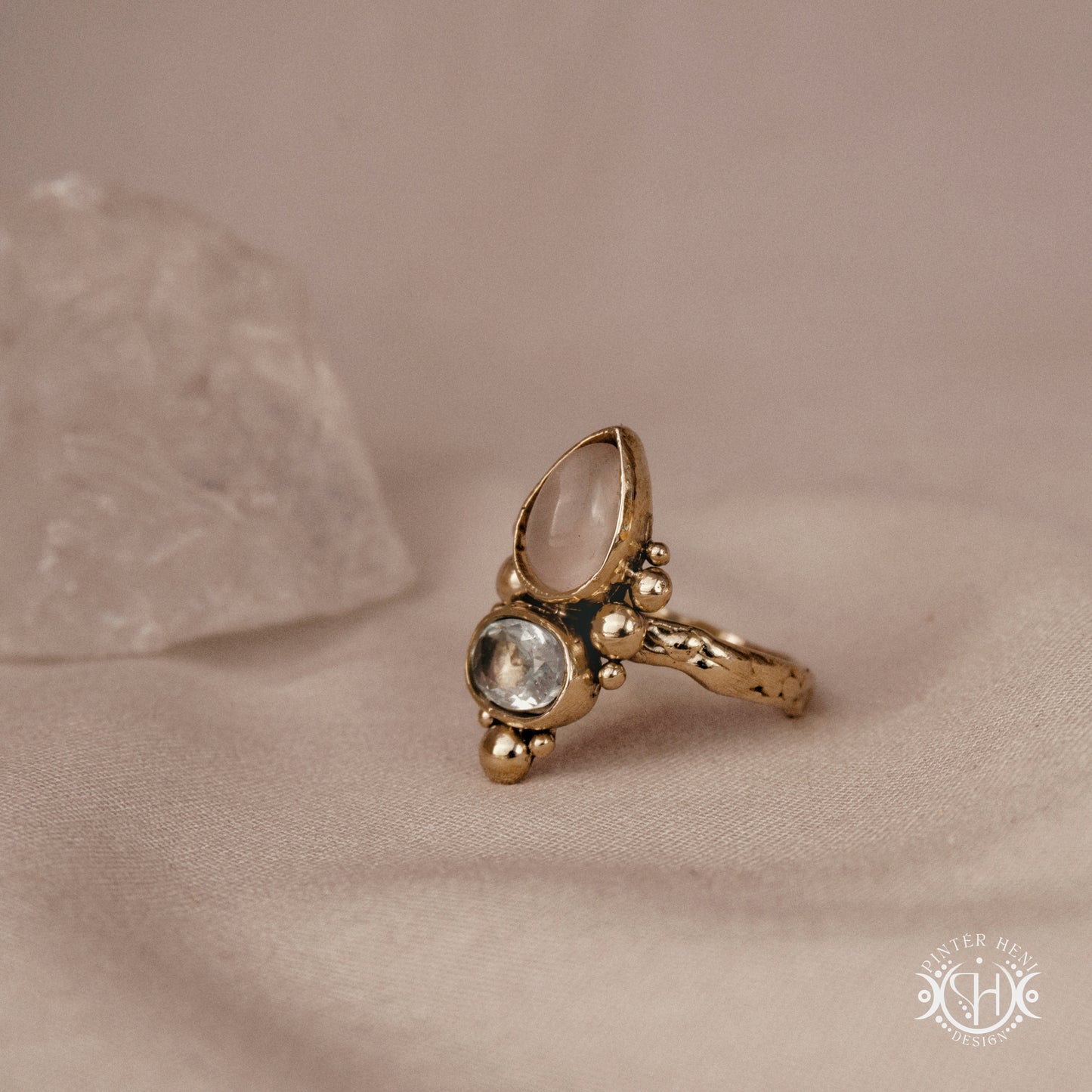 Handmade Kore ring with rose quartz and aquamarine in balanced sculptural setting