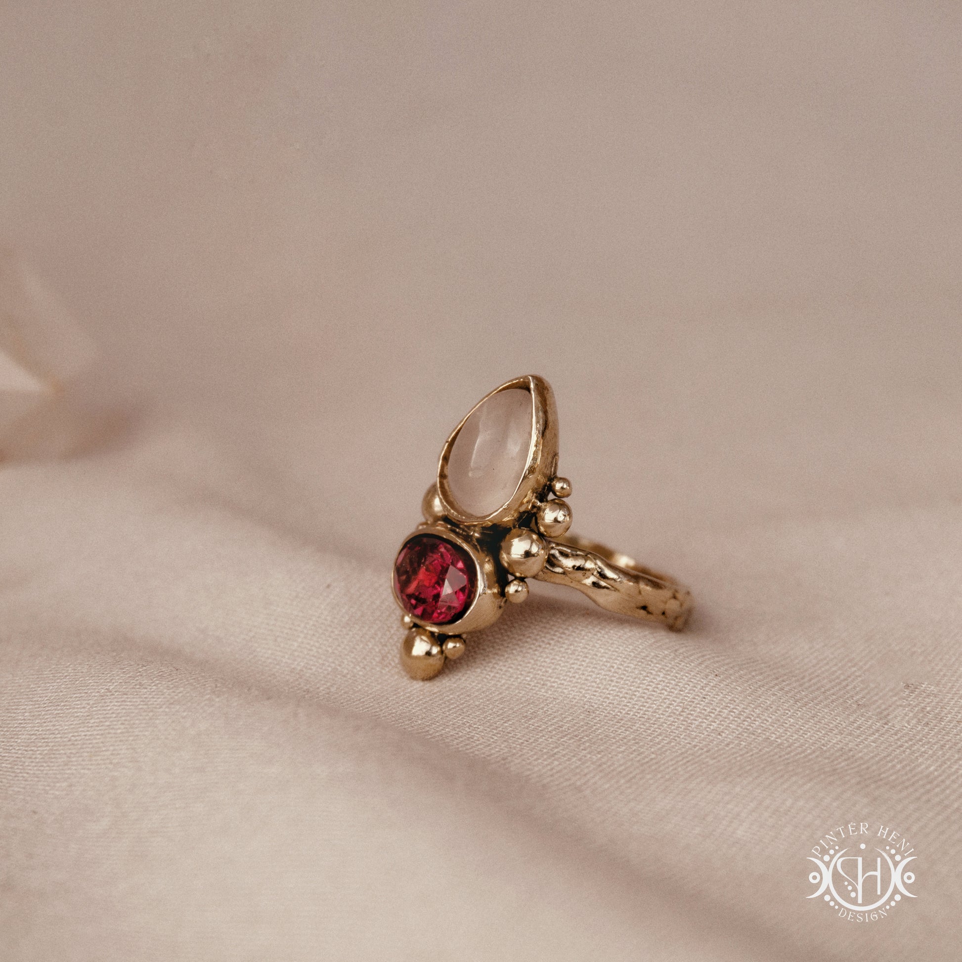 Handmade Kore ring with rose quartz and garnet in balanced sculptural setting