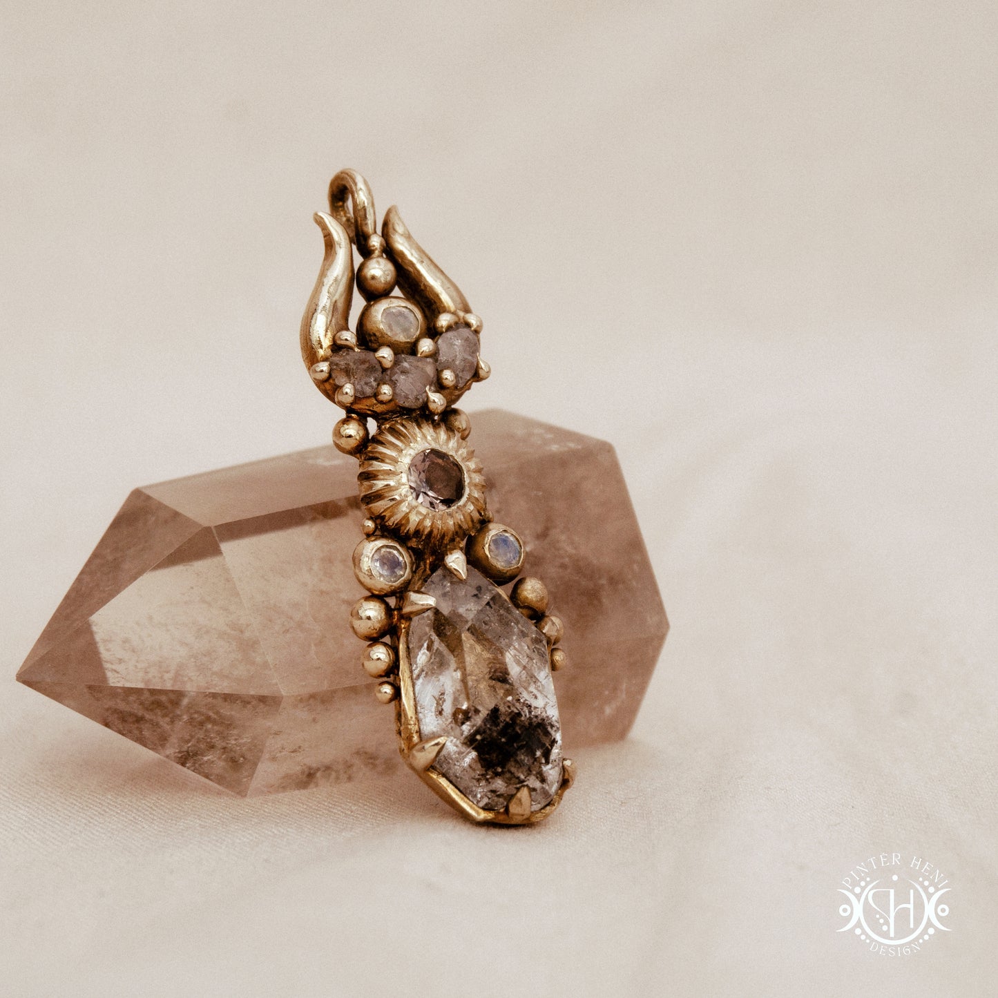 One of a kind Lunar Desert Rites pendant with crescent form, raw sapphire, pink tourmaline, moonstone and Herkimer crystal