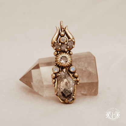 One of a kind Lunar Desert Rites pendant with crescent form, raw sapphire, pink tourmaline, moonstone and Herkimer crystal