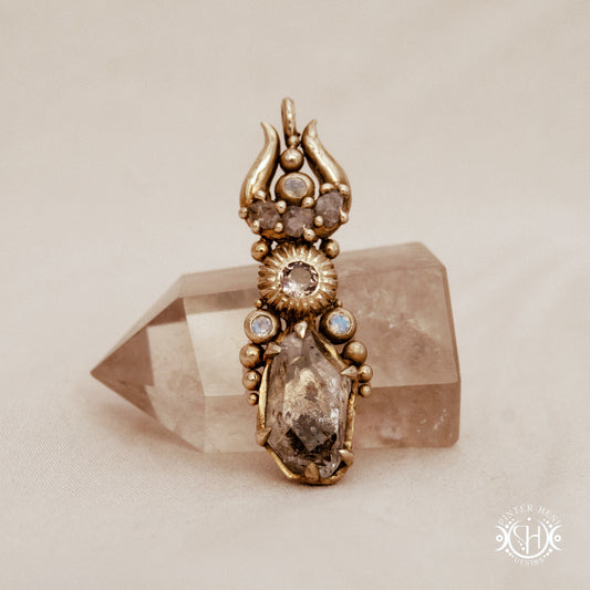 One of a kind Lunar Desert Rites pendant with crescent form, raw sapphire, pink tourmaline, moonstone and Herkimer crystal