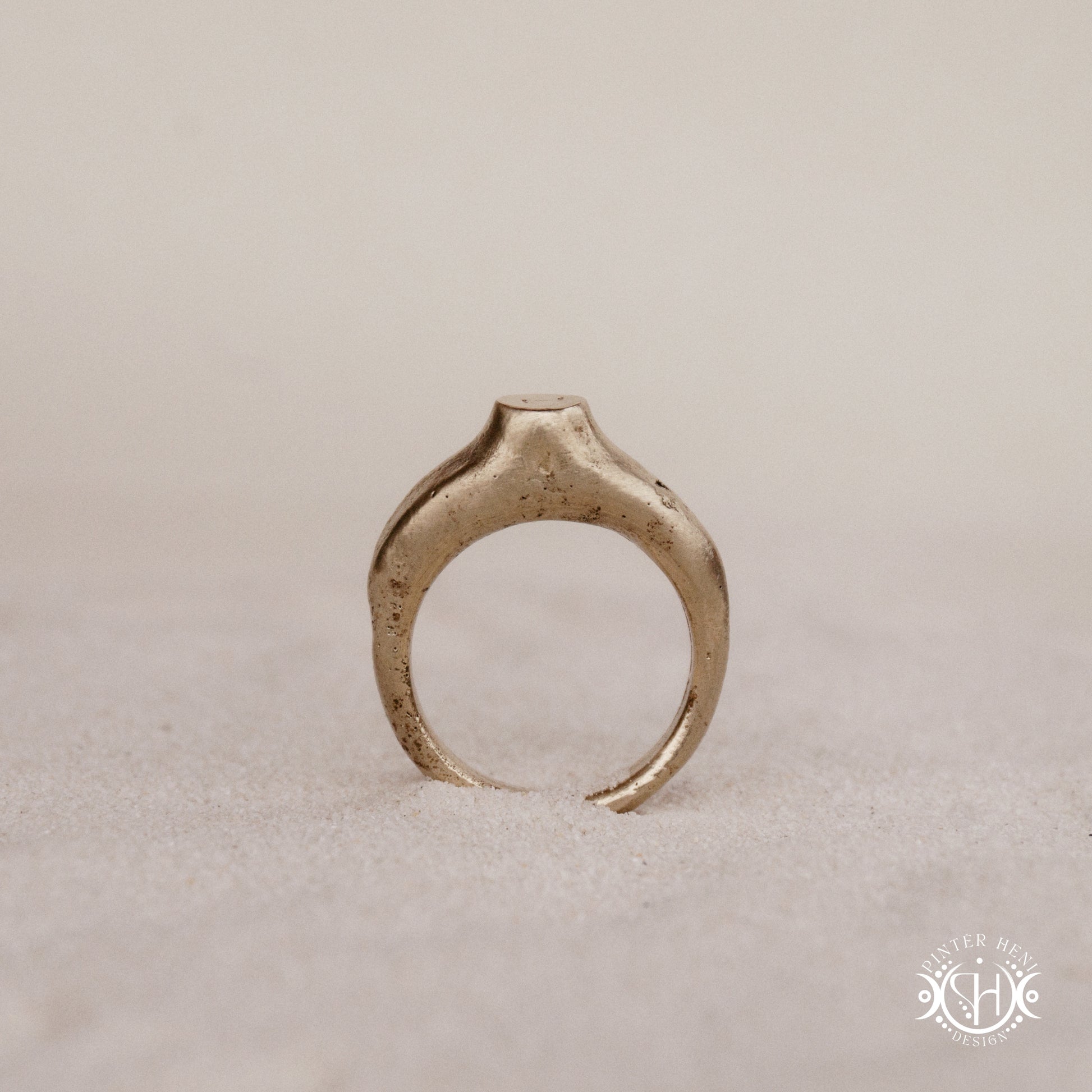 Monolith Ring handmade sandcast brass ring with raised vertical sculptural top, primitive and ancient-inspired form, in sand.