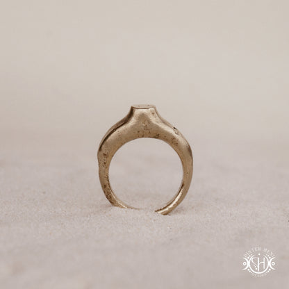 Monolith Ring handmade sandcast brass ring with raised vertical sculptural top, primitive and ancient-inspired form, in sand.