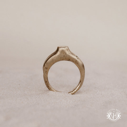 Monolith Ring handmade sandcast brass ring with raised vertical sculptural top, primitive and ancient-inspired form, in sand.