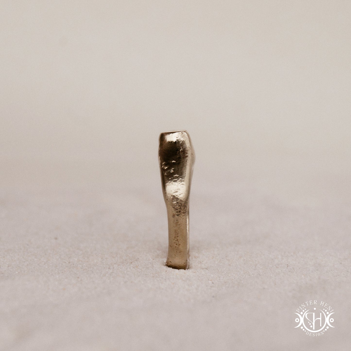 Monolith Ring handmade sandcast brass ring with raised vertical sculptural top, primitive and ancient-inspired form, in sand.