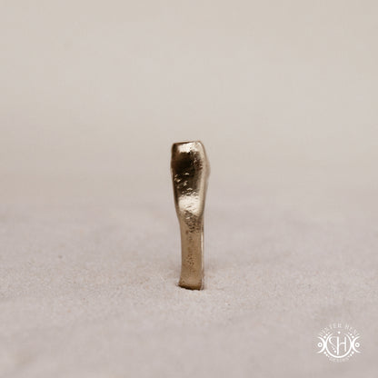 Monolith Ring handmade sandcast brass ring with raised vertical sculptural top, primitive and ancient-inspired form, in sand.
