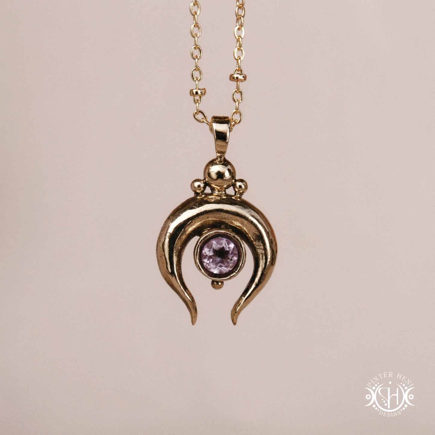 Hand-carved crescent moon pendant in brass with amethyst from the Primal Symbols collection. Symbolic jewelry made to order in brass, silver, and gold.
