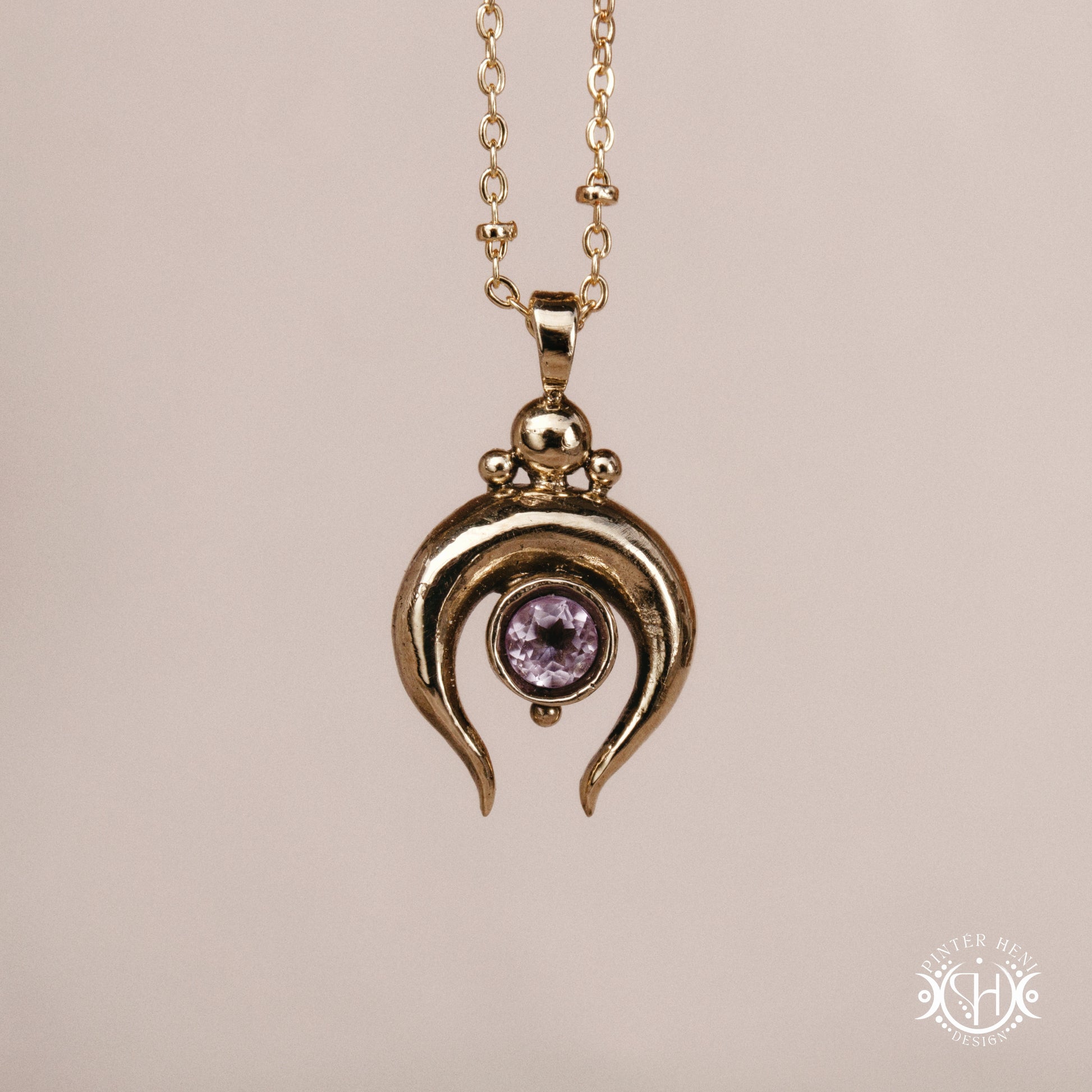 Hand-carved crescent moon pendant in brass with amethyst from the Primal Symbols collection. Symbolic jewelry made to order in brass, silver, and gold.