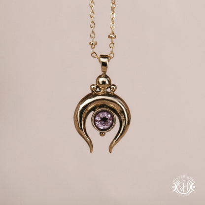 Hand-carved crescent moon pendant in brass with amethyst from the Primal Symbols collection. Symbolic jewelry made to order in brass, silver, and gold.