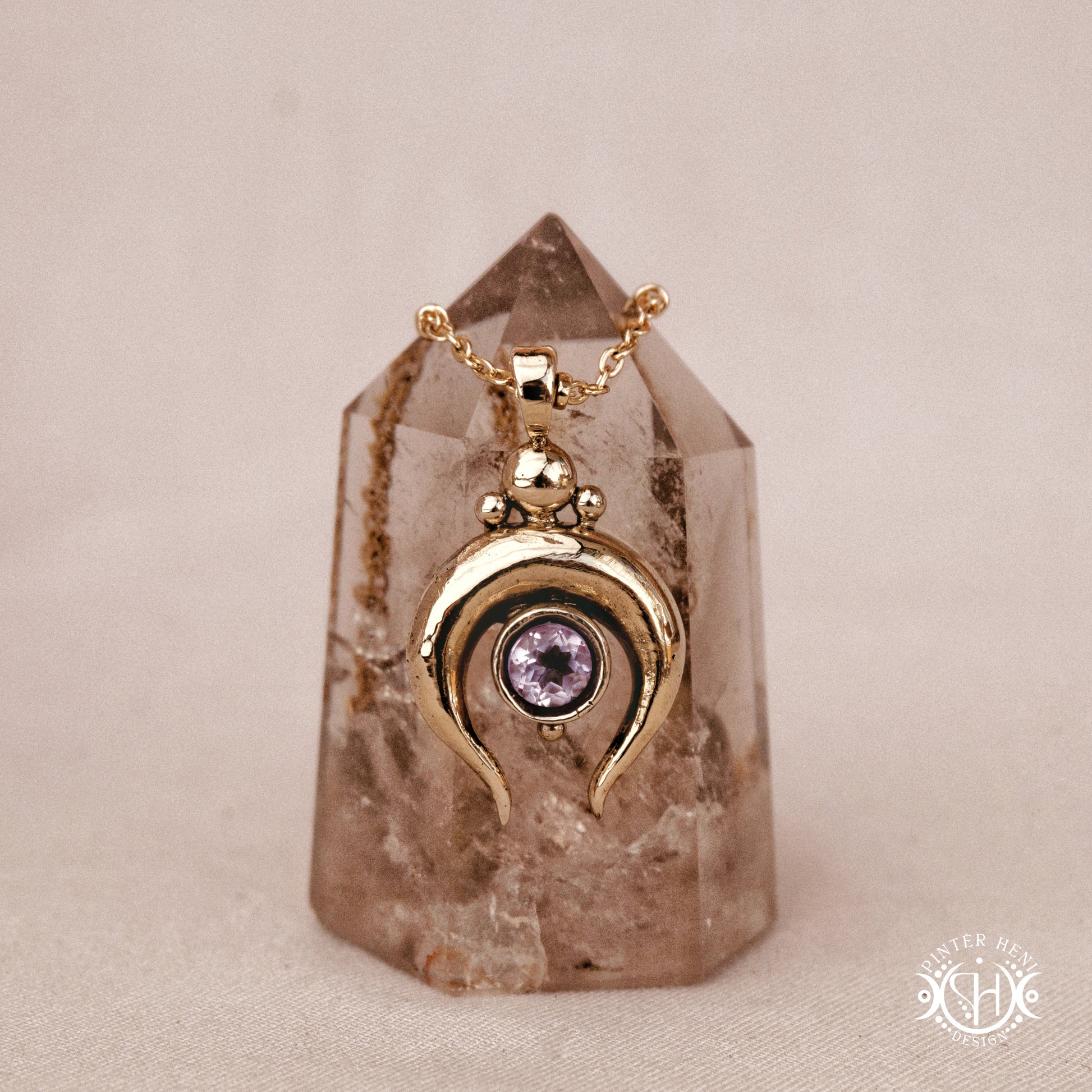 Hand-carved crescent moon pendant in brass with amethyst from the Primal Symbols collection. Symbolic jewelry made to order in brass, silver, and gold.