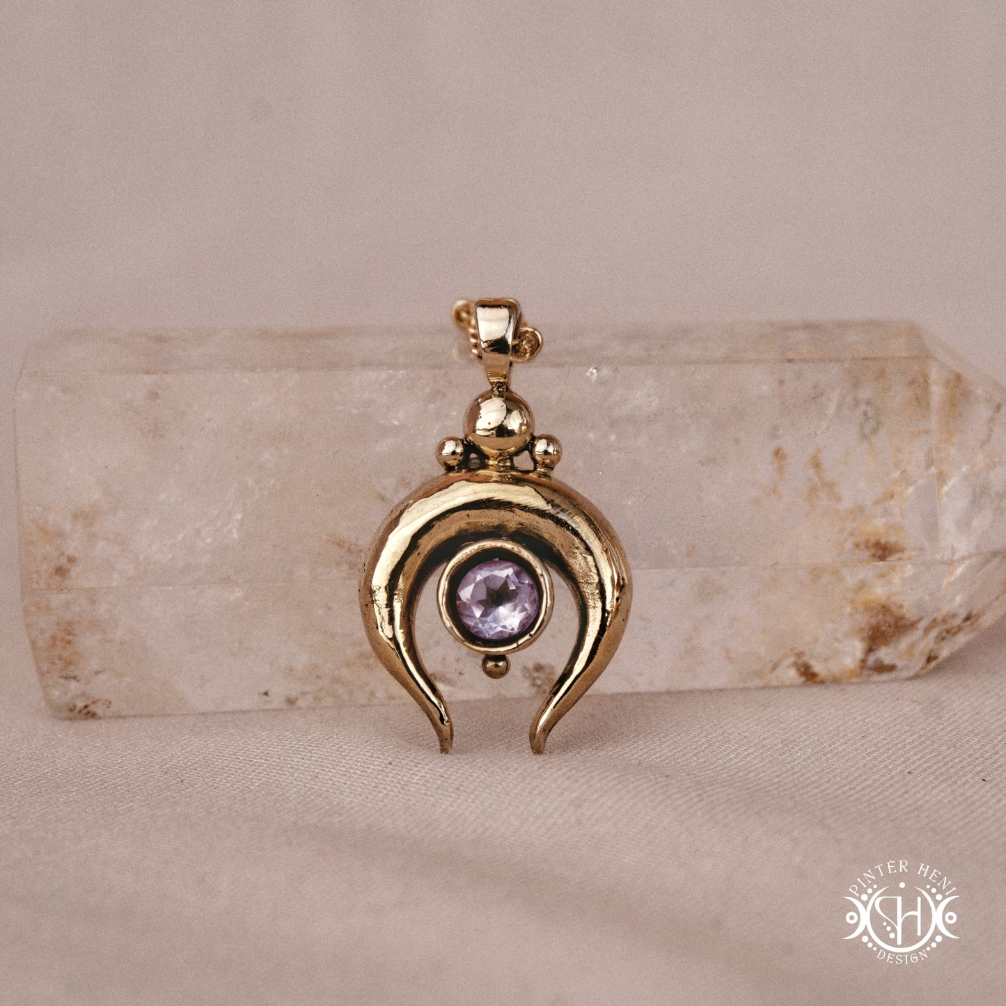 Hand-carved crescent moon pendant in brass with amethyst from the Primal Symbols collection. Symbolic jewelry made to order in brass, silver, and gold.