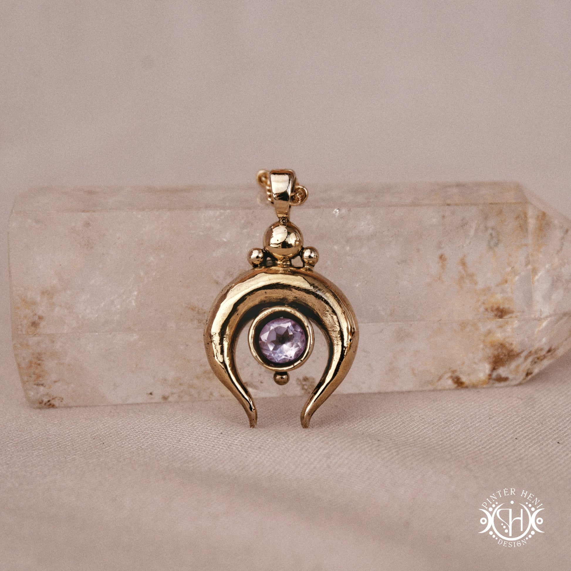Hand-carved crescent moon pendant in brass with amethyst from the Primal Symbols collection. Symbolic jewelry made to order in brass, silver, and gold.