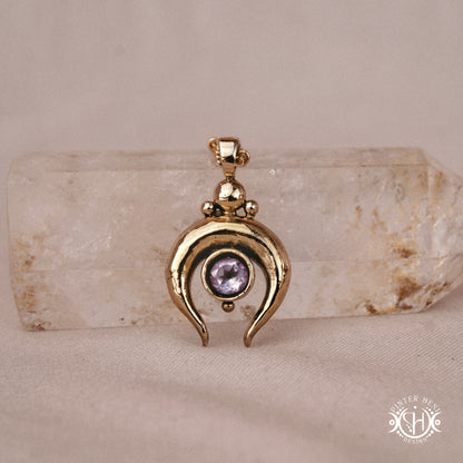 Hand-carved crescent moon pendant in brass with amethyst from the Primal Symbols collection. Symbolic jewelry made to order in brass, silver, and gold.